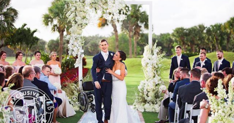 Paralyzed football player defies odds, walks down the aisle at his wedding
