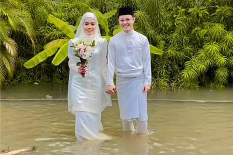 VIDEO: Malaysian couple holds wedding reception in knee-deep floods